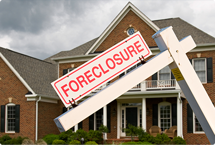 A house with a foreclosure sign in front of it